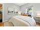 Bright main bedroom with ample natural light, artwork, and a plush bed with decorative pillows at 635 Fillmore St, Denver, CO 80206