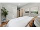 Spacious bedroom featuring a plush bed and a potted tree at 635 Fillmore St, Denver, CO 80206