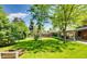 Lush backyard featuring well-maintained lawn, mature trees, and ample green space for outdoor activities at 7005 S Ash Cir, Centennial, CO 80122