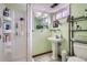 Basement bathroom with shower, pedestal sink, and storage at 7005 S Ash Cir, Centennial, CO 80122