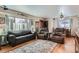 Comfortable living room featuring hardwood floors, a large window, and cozy seating arrangements at 7005 S Ash Cir, Centennial, CO 80122