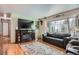 Living room features hardwood floors, fireplace, and large windows at 7005 S Ash Cir, Centennial, CO 80122