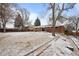 Large backyard of a red brick home, partially covered in snow at 31 W Fremont Ave, Littleton, CO 80120