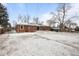 Expansive backyard features a brick home, patio area, and a snow-covered lawn at 31 W Fremont Ave, Littleton, CO 80120