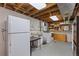 Functional basement laundry area with washer, dryer and refrigerator at 31 W Fremont Ave, Littleton, CO 80120