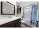 Bright bathroom features a large mirror, new vanity and a shower and tub combination at 31 W Fremont Ave, Littleton, CO 80120