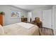 Cozy bedroom features neutral color scheme and an abundance of natural light from a large window at 31 W Fremont Ave, Littleton, CO 80120