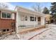 Inviting covered front porch with white railing and brick accents at 31 W Fremont Ave, Littleton, CO 80120