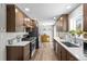 Well-lit kitchen featuring wood cabinets, stainless steel appliances, and quartz countertops at 31 W Fremont Ave, Littleton, CO 80120