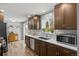 Well-lit kitchen featuring stainless steel appliances, wood-look floors, and ample counter space at 31 W Fremont Ave, Littleton, CO 80120