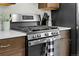 Stainless steel gas range with oven below, set into dark wood cabinets with light countertop at 31 W Fremont Ave, Littleton, CO 80120