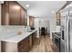 Modern kitchen with stainless appliances, wood floors, bright lighting, and long countertops at 31 W Fremont Ave, Littleton, CO 80120