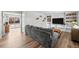 Bright living room featuring hardwood floors, a large gray couch, and built in shelving at 31 W Fremont Ave, Littleton, CO 80120