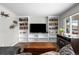 Inviting living room with a large built-in bookcase and hardwood flooring at 31 W Fremont Ave, Littleton, CO 80120