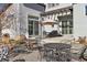Backyard patio area featuring multiple seating areas and an umbrella for shade at 65 Newport St, Denver, CO 80230