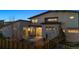 Backyard patio with outdoor dining, mature trees, and privacy fence at 65 Newport St, Denver, CO 80230