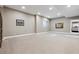 Spacious finished basement featuring neutral carpeting and ample lighting at 65 Newport St, Denver, CO 80230