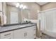 Bright bathroom featuring a gray granite countertop, white cabinets, and a shower with white tile at 65 Newport St, Denver, CO 80230