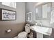 Elegant half-bathroom featuring pedestal sink, modern fixtures, and stylish decorative accents at 65 Newport St, Denver, CO 80230