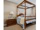 Bedroom with a four poster bed, side table with a lamp at 65 Newport St, Denver, CO 80230