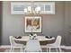 Bright dining area featuring a modern chandelier and a stylish white table set for four at 65 Newport St, Denver, CO 80230