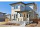 Contemporary home featuring a stone facade, covered porch, and stylish railing at 65 Newport St, Denver, CO 80230
