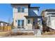 Contemporary home featuring a stone facade, covered porch, and stylish railing at 65 Newport St, Denver, CO 80230