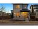 Home front exterior showcases modern design with brick, steel porch, and xeriscaped front yard at 65 Newport St, Denver, CO 80230