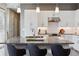 Bright kitchen with a granite island, pendant lighting, stainless appliances, and modern white cabinets at 65 Newport St, Denver, CO 80230
