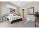 Light-filled bedroom with neutral colors, a cozy bed, and ample natural light through large windows at 65 Newport St, Denver, CO 80230