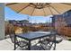 Back patio featuring outdoor furniture, a shade umbrella, and a privacy fence at 65 Newport St, Denver, CO 80230