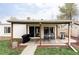 Cozy covered patio with grill, table and chairs offers a perfect space for outdoor dining and relaxation at 873 S Raritan St, Denver, CO 80223