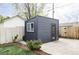 Backyard shed featuring a window and door, surrounded by landscaping, providing a versatile outdoor space at 873 S Raritan St, Denver, CO 80223