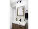 Chic bathroom featuring a wood vanity, modern faucet, and stylish mirror at 873 S Raritan St, Denver, CO 80223