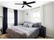Comfortable bedroom with hardwood floors, large windows and blue accents at 873 S Raritan St, Denver, CO 80223