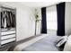 Bedroom with an organized closet, and lots of natural light at 873 S Raritan St, Denver, CO 80223