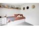 Cozy bedroom features rustic shelf, stylish decor, and a comfy bed, perfect for relaxation and peaceful living at 873 S Raritan St, Denver, CO 80223