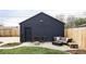 Garage with a patio featuring a cozy seating area around a fire pit, perfect for outdoor gatherings at 873 S Raritan St, Denver, CO 80223
