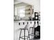 Bright, open concept kitchen featuring barstool seating and natural light at 873 S Raritan St, Denver, CO 80223
