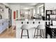 Open concept kitchen with island, barstool seating and shaker cabinets at 873 S Raritan St, Denver, CO 80223