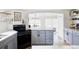 Modern kitchen features an island, stone countertops and stainless steel appliances at 873 S Raritan St, Denver, CO 80223