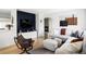 Cozy living room with a modern accent wall, hardwood floors, and comfortable seating at 873 S Raritan St, Denver, CO 80223