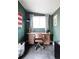 Interior of shed setup as an office with a desk, chair, and natural light from a window, perfect workspace at 873 S Raritan St, Denver, CO 80223