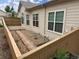 Home exterior featuring a small rock garden, patio and a light wood fence with views of other houses in the neighborhood at 71 Woodland Cir, Highlands Ranch, CO 80126