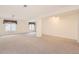 Spacious basement area featuring neutral carpet and ample natural light from two windows at 71 Woodland Cir, Highlands Ranch, CO 80126