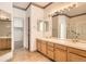 Well-lit bathroom with double sinks, and a glass-enclosed shower at 71 Woodland Cir, Highlands Ranch, CO 80126