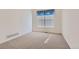 Bright bedroom featuring neutral carpet, white walls, and a window with blinds at 71 Woodland Cir, Highlands Ranch, CO 80126