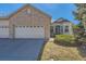 Charming brick home with attached two-car garage and well-maintained front yard at 71 Woodland Cir, Highlands Ranch, CO 80126
