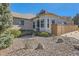 View of the exterior with landscaping and large boulders at 71 Woodland Cir, Highlands Ranch, CO 80126
