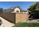 Charming single story home featuring a wooden fence, manicured lawn, and inviting curb appeal at 71 Woodland Cir, Highlands Ranch, CO 80126